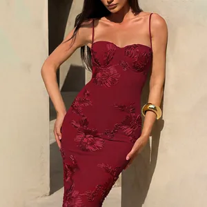 Close-up of elegant burgundy bodycon dress with intricate floral embroidery and straps