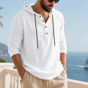 Men's white long sleeve hooded Henley linen t-shirt shown in outdoor beach setting.