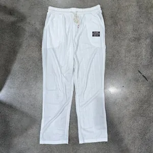 Macro detail of men's white waffle knit breathable casual straight-leg trousers