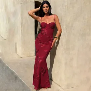 Detailed view of burgundy floral embroidered backless maxi dress in sunlight