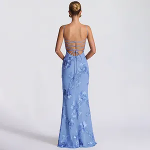 Back detail view of a light blue maxi dress featuring floral lace and lace-up design