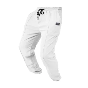 Men's white waffle knit casual joggers with drawstring waist and textured honeycomb fabric.
