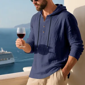 Man wearing a navy blue linen-textured hooded Henley T-shirt on a cruise ship balcony