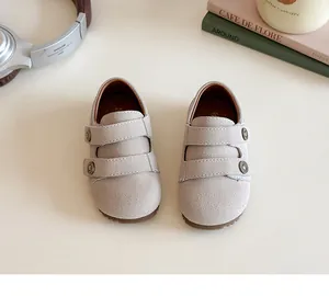 Top view of beige toddler walking shoes with double velcro straps and suede texture