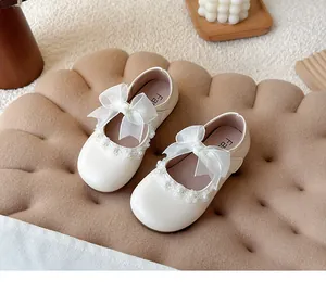Elegant white girls Mary Jane shoes with a delicate lace bow and pearl flower details
