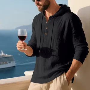Detail of black linen hooded Henley t-shirt for men in a relaxed vacation setting