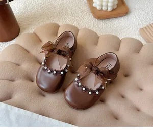 Elegant brown Mary Jane shoes for girls with lace bow and pearl details