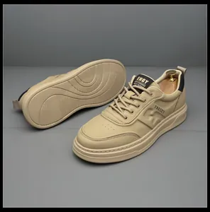 Premium beige men's leather sneakers showing sole texture and side profile details