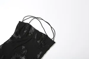 Detailed macro view of black summer bustier dress featuring elegant floral lace appliques.