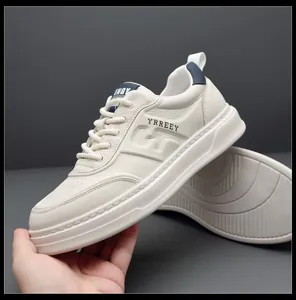 Minimalist white leather sneakers for men with thick sole and navy blue accents