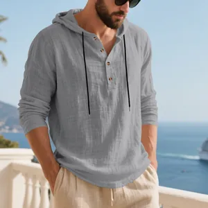 Close-up detail of a men's breathable gray linen hooded Henley t-shirt at the beach