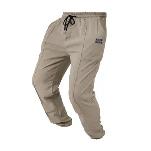 Close-up detail of khaki men's waffle texture breathable sports straight joggers