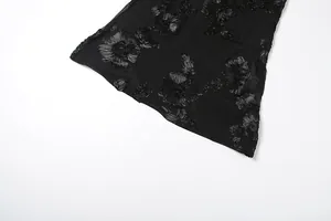 Macro detail of exquisite 3D floral embroidery on elegant black summer maxi dress