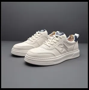 Detailed macro view of white men's fashion sneakers with navy accents and textured leather