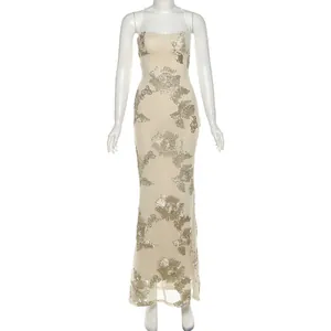 Elegant champagne evening gown with silver floral sequins displayed on a white mannequin