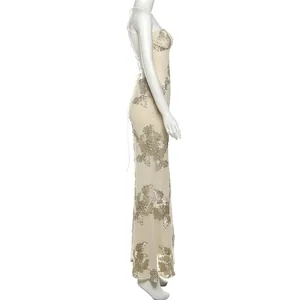 Detailed side view of an elegant backless lace-up maxi dress with gold floral embroidery