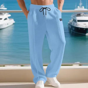 Detailed view of men's breathable light blue waffle knit straight leg lounge pants