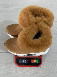 Detail view of winter brown suede snow boots with thick fur lining weighing 591g on a scale