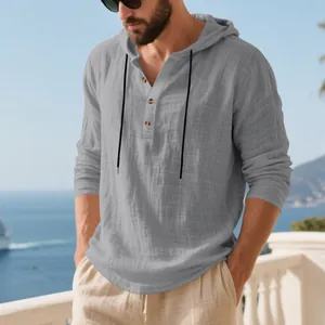 Detailed macro view of grey linen texture and button placket on a men's hooded shirt
