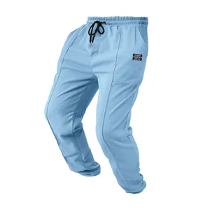 Close-up of light blue men's sports pants featuring a waffle texture and drawstring waist