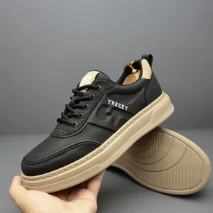 Stylish men's black leather sneakers with a chunky beige sole and side brand logo detail