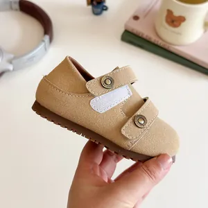 Beige suede children's walker shoes featuring double velcro straps and comfortable soles