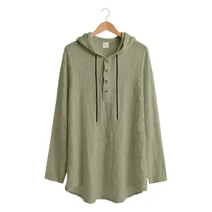 Detail view of a sage green linen hooded Henley shirt for men with wooden buttons