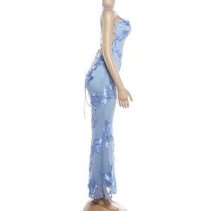 Detailed side view of a light blue backless maxi dress with floral lace embroidery