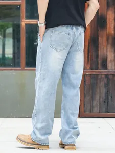 Rear view of loose fit light blue denim jeans with back pocket details for men