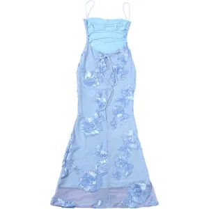 Back view of light blue maxi dress with floral embroidery and criss-cross lace-up detail.