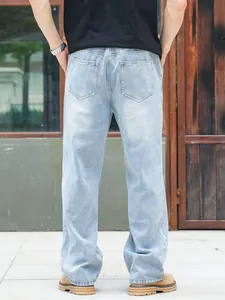 Detailed back view of men's loose straight-leg denim jeans in a light blue wash color.