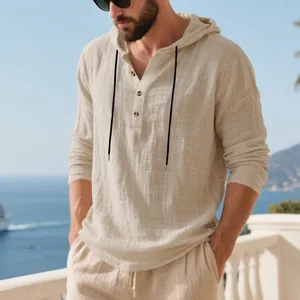 Detailed shot of a breathable beige linen hooded Henley shirt for men in a seaside setting