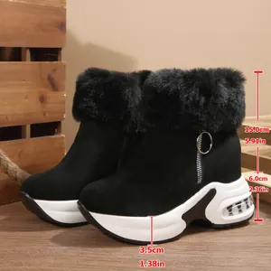 Detailed view of women's black fur-lined platform snow boots with height measurements
