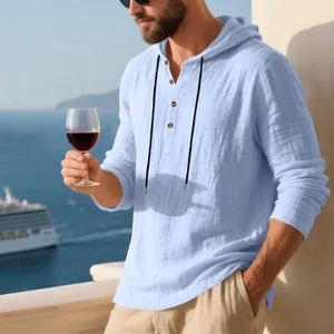 Lifestyle detail of a light blue linen hooded Henley shirt for men on a balcony