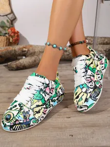 Detailed view of colorful graffiti print platform sneakers with white laces.