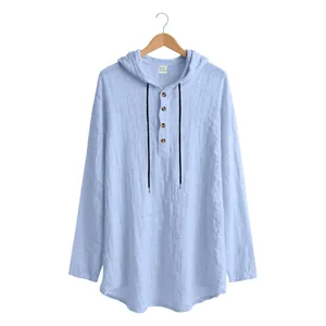 Close-up detail of light blue men's hooded linen shirt with fabric texture and buttons