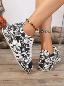 Close-up detail of black and white cartoon print on platform sneakers with laces
