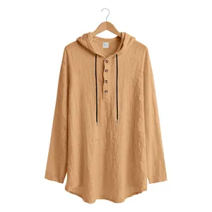 Detail of ginger men's linen-blend hooded Henley shirt showing button placket and texture