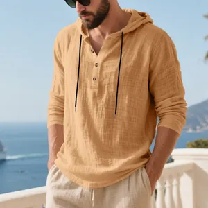 Close-up of a breathable linen hooded Henley shirt for men in a casual beach setting