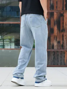 Back view of light blue straight denim jeans with raw hem for men's fashion