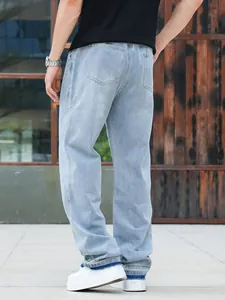 Detailed back view of men's loose light blue straight denim jeans with pocket design
