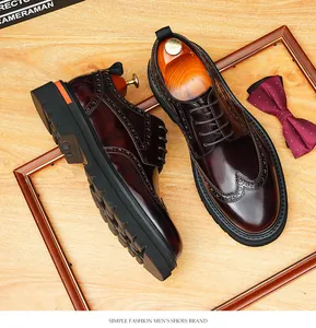 Detailed macro view of men's burgundy shiny leather brogue derby shoes with thick soles.