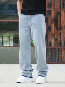 Detail view of men's light blue wide-leg jeans with unique layered raw hem design
