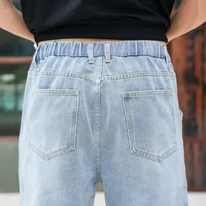 Detail view of men's straight-leg jeans featuring a comfortable elastic waistband.