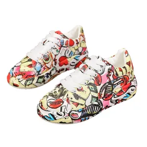 Vibrant graffiti print women's platform sneakers with thick sole and white laces.