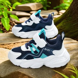 Boys breathable mesh sports sneakers with velcro straps in outdoor natural setting