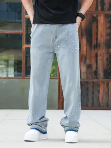 Men's light blue straight-leg loose denim jeans with white pearl embellishments in front view.