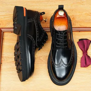 Men's shiny black brogue Derby shoes with thick sole and vintage wingtip design.