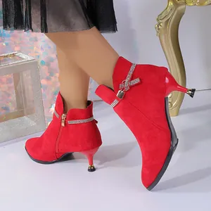 Elegant red suede pointed-toe ankle boots featuring kitten heels and rhinestone trim