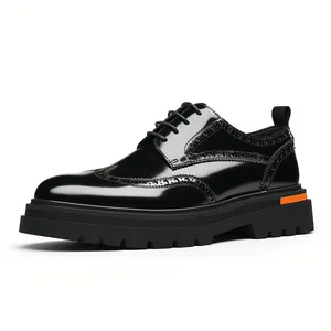 Men's shiny black leather brogue derby shoes with chunky lug sole and orange detail